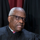Associate Justice Clarence Thomas joins other members of the Supreme Court as they pose for a new group portrait, at the Supreme Court building in Washington, Friday, Oct. 7, 2022.